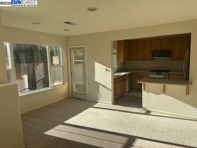 7187 Briza Loop San Ramon, CA 94582 - Photo 2 of 26 a view of a kitchen with microwave and refrigerator