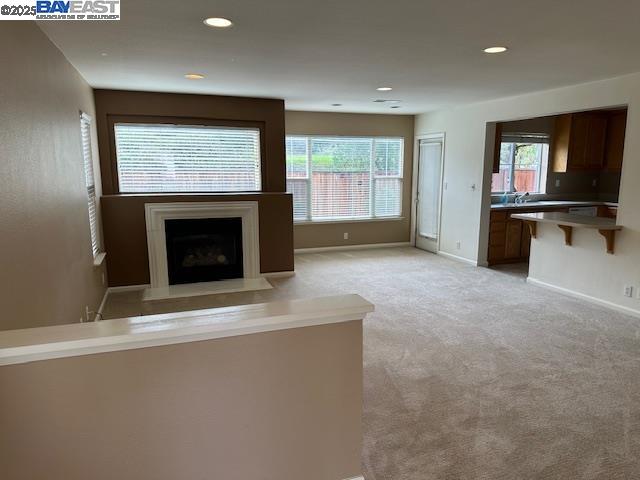 7187 Briza Loop San Ramon, CA 94582 - Photo 4 of 23 an empty room with windows fireplace and sink