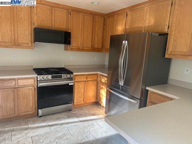 7187 Briza Loop San Ramon, CA 94582 - Photo 7 of 26 a kitchen with stainless steel appliances granite countertop a refrigerator stove and microwave