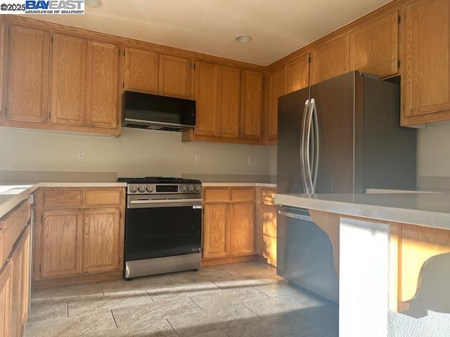 7187 Briza Loop San Ramon, CA 94582 - Photo 8 of 26 a kitchen with stainless steel appliances granite countertop a refrigerator stove and microwave
