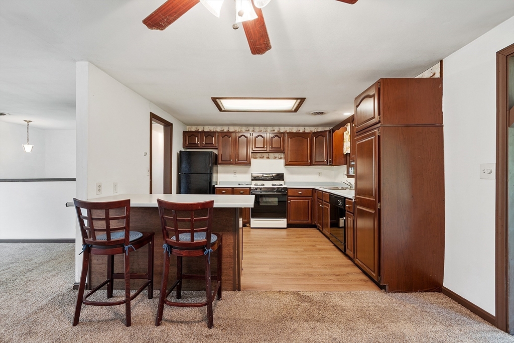 25 Cushing Street Salisbury, MA 01952 - Photo 12 of 40 a kitchen with stainless steel appliances kitchen island granite countertop furniture and a refrigerator