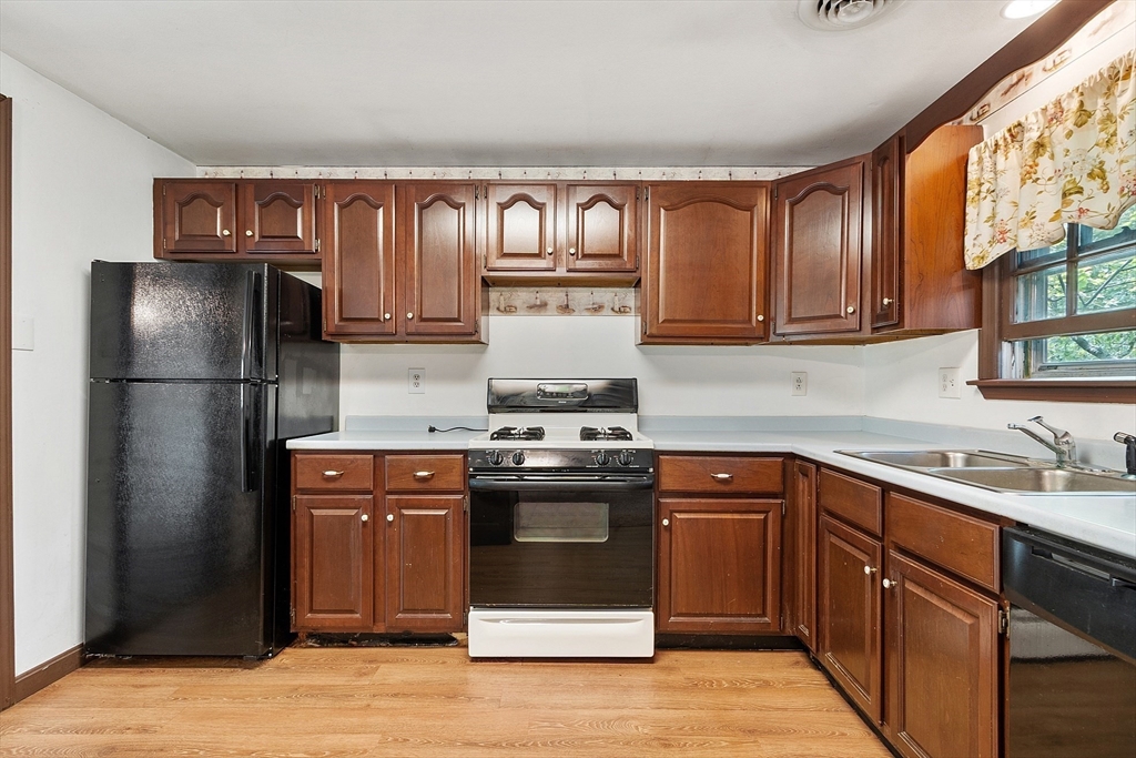 25 Cushing Street Salisbury, MA 01952 - Photo 13 of 40 a kitchen with stainless steel appliances granite countertop a stove and a refrigerator