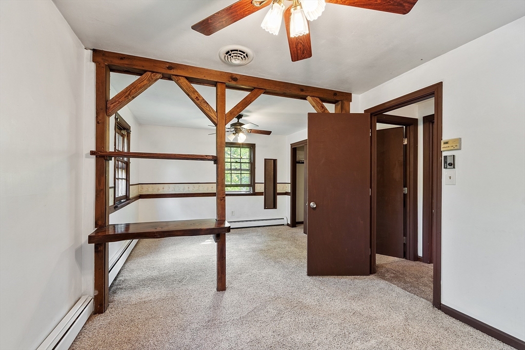 25 Cushing Street Salisbury, MA 01952 - Photo 19 of 40 an empty room with a ceiling fan and window
