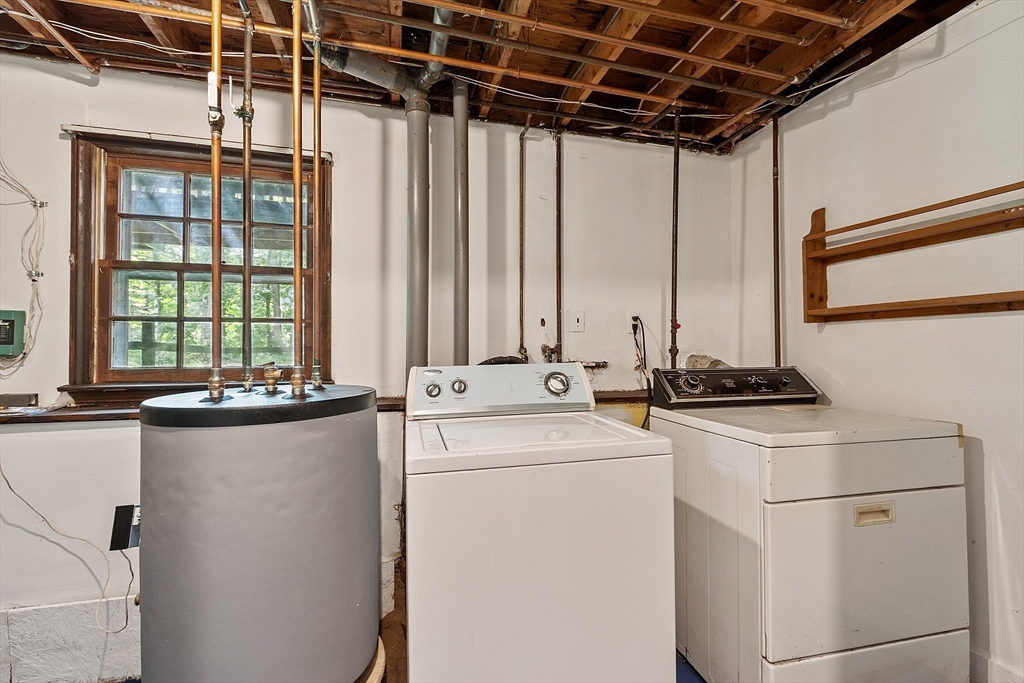 25 Cushing Street Salisbury, MA 01952 - Photo 28 of 40 a view of washer and dryer with chandelier