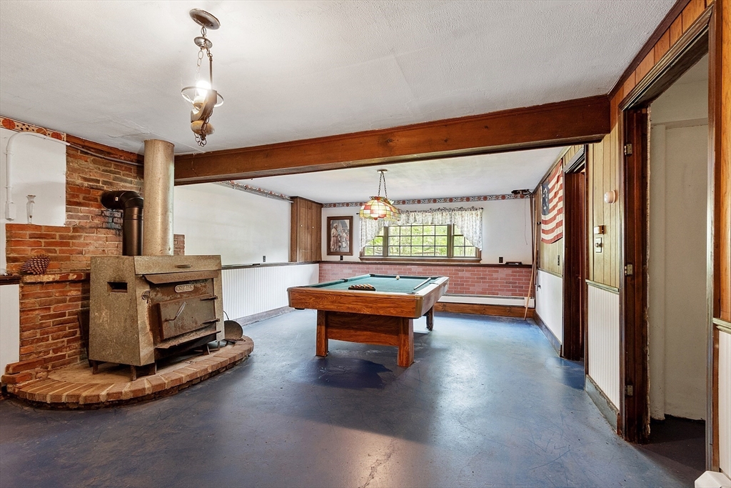 25 Cushing Street Salisbury, MA 01952 - Photo 32 of 40 a dining room with furniture a fireplace and wooden floor