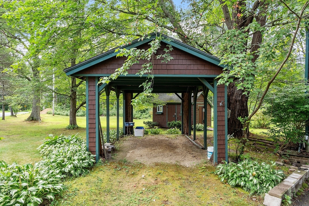 25 Cushing Street Salisbury, MA 01952 - Photo 36 of 40 a view of a barn with big yard plants and large trees