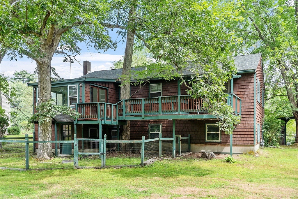25 Cushing Street Salisbury, MA 01952 - Photo 5 of 40 a front view of a house with a yard table and chairs