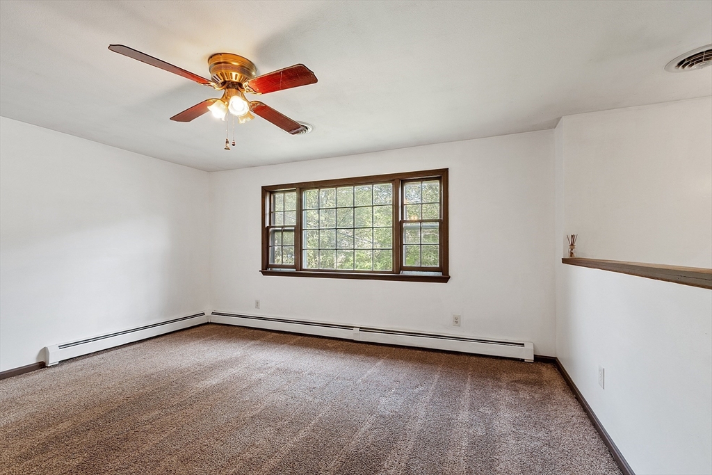 25 Cushing Street Salisbury, MA 01952 - Photo 10 of 40 an empty room with windows and fan
