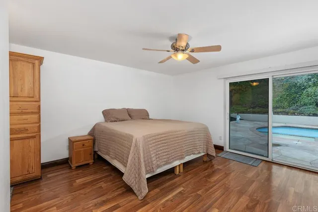 a bedroom with a bed and a ceiling fan