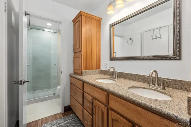 a bathroom with a granite countertop sink mirror double vanity