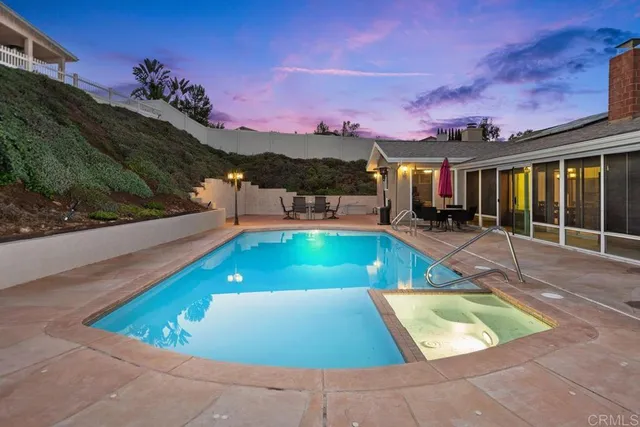 a view of a pool with a outdoor seating