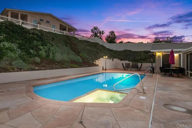 a view of a swimming pool with a table and chairs