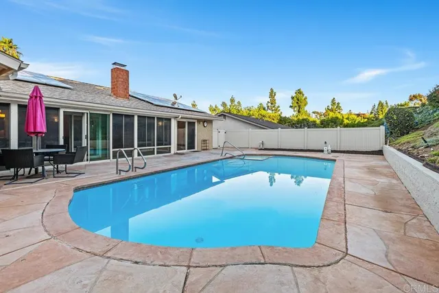 a view of a swimming pool with outdoor seating