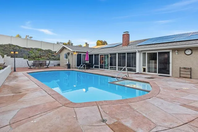 a view of a house with swimming pool and porch