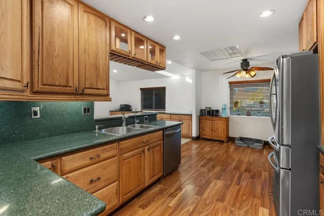 a kitchen with granite countertop stainless steel appliances and wooden cabinets