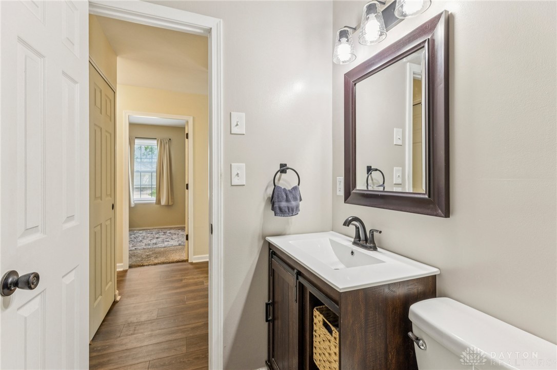 4934 Castleton Drive Fairfield, OH 45014 - Photo 24 of 36 This bathroom features elegant wood flooring, a vanity with a sleek sink, and a modern mirror.