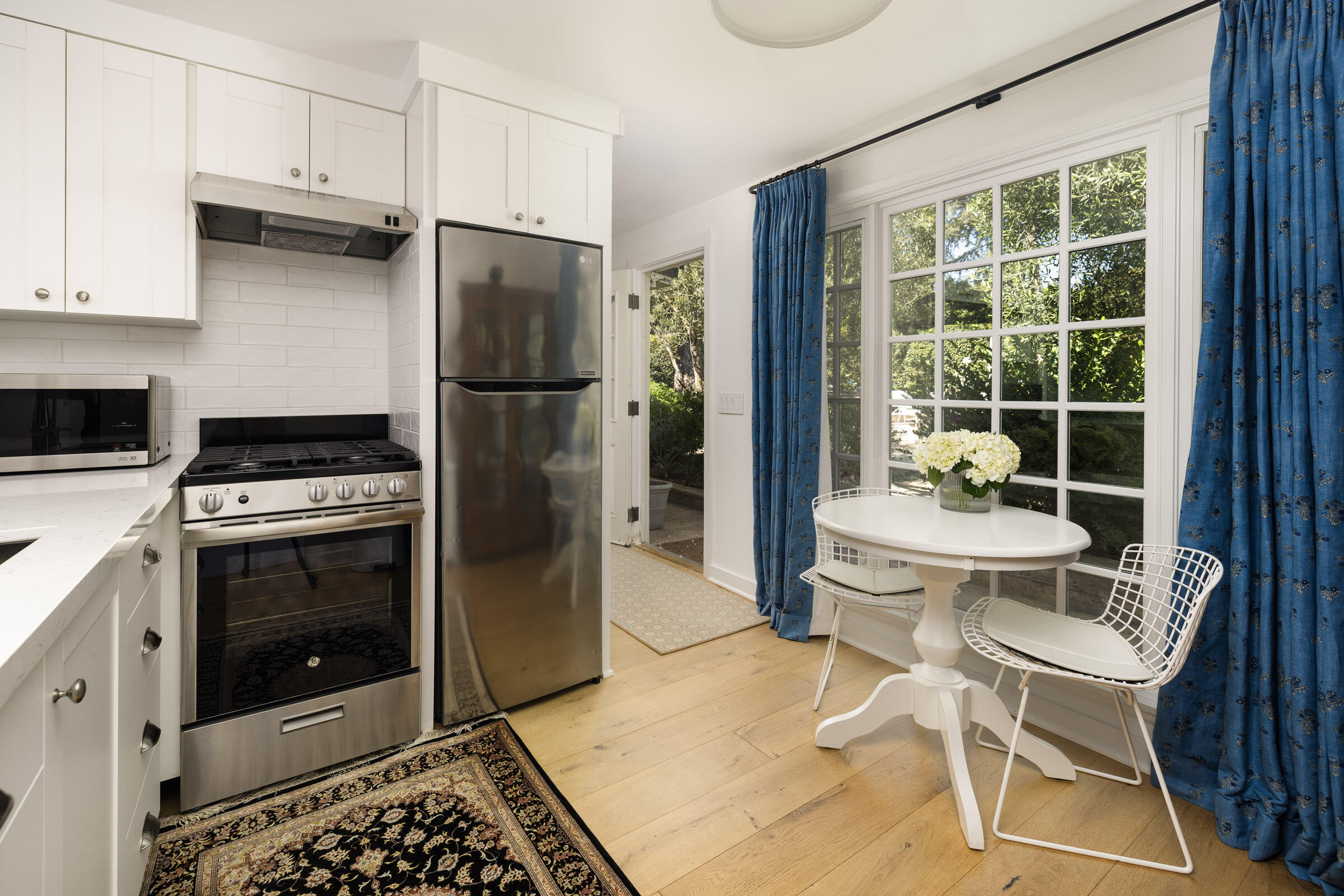 1166 Summit Road Montecito, CA 93108 - Photo 31 of 42 a kitchen with stainless steel appliances kitchen island granite countertop a refrigerator a stove a sink and white cabinets with wooden floor