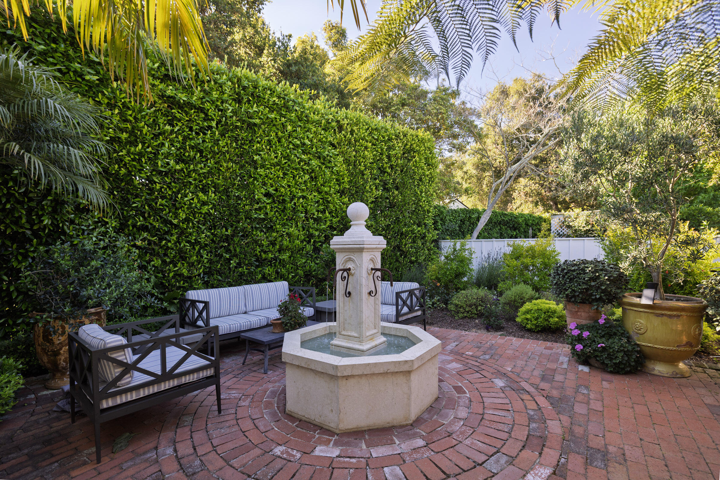 1166 Summit Road Montecito, CA 93108 - Photo 38 of 42 a view of a patio with table and chairs potted plants and wooden fence