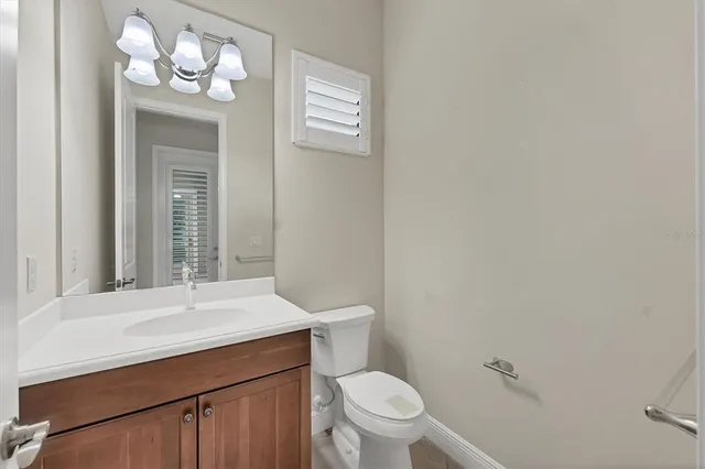 a bathroom with a sink a toilet a mirror and shower