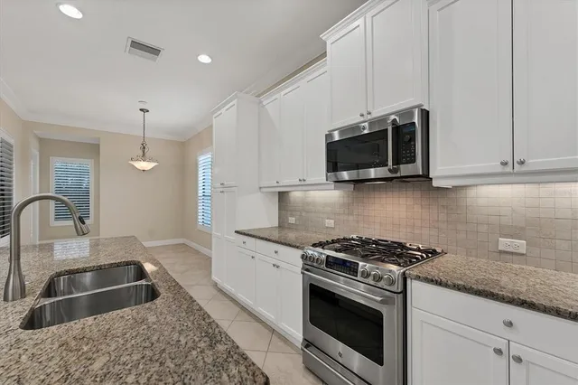 a utility room with sink dryer and washer