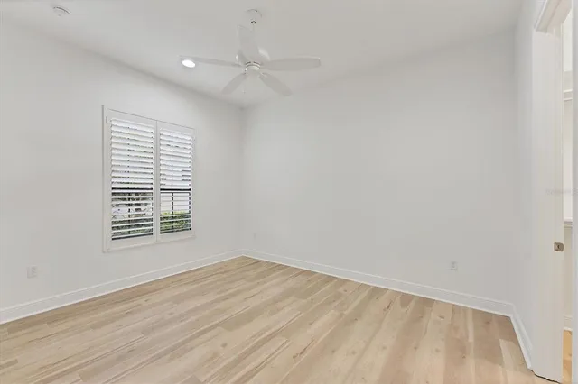 an aerial view of a swimming pool with a patio and garden