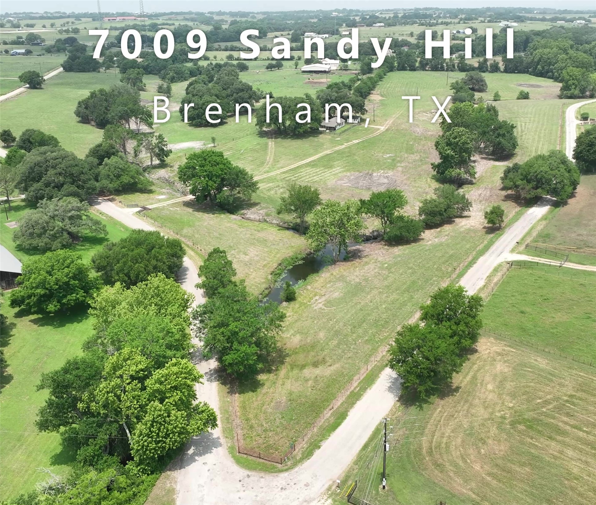 7009 Sandy Hill Road Brenham, TX 77833 - Photo 1 of 41 a view of outdoor space with a garden and signage