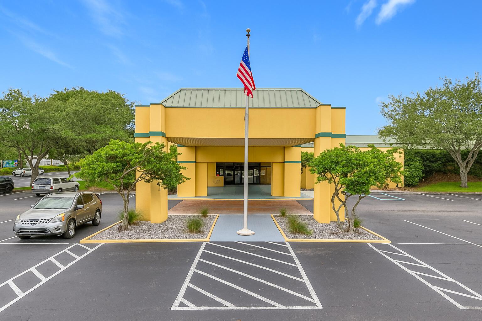 910 Suemac Road Jacksonville, FL 32254 - Photo 3 of 32 Yellow Building with American Flag