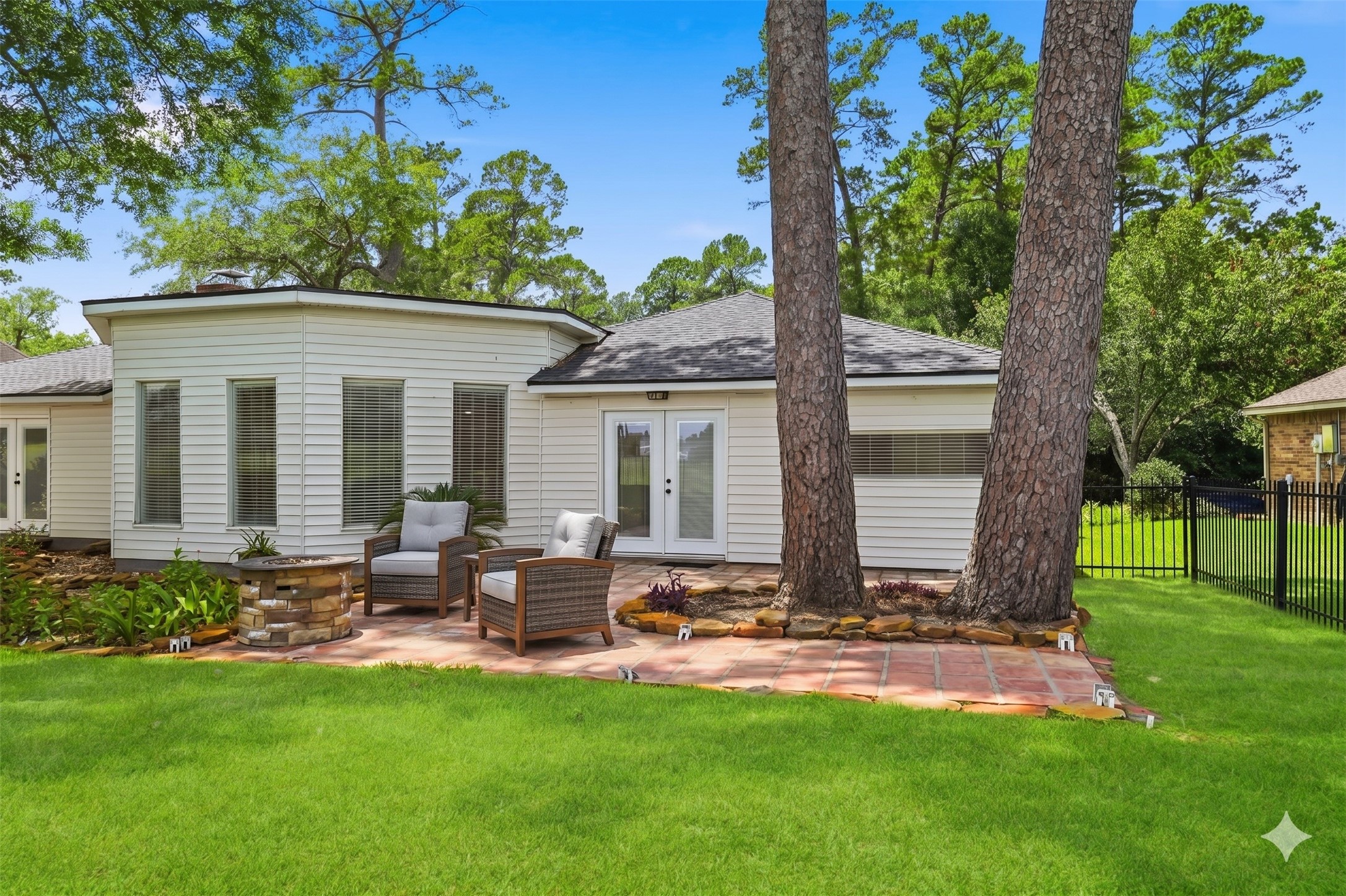 79 Summers Wind Street Conroe, TX 77356 - Photo 37 of 45 a view of a backyard with table and chairs potted plants and a large tree