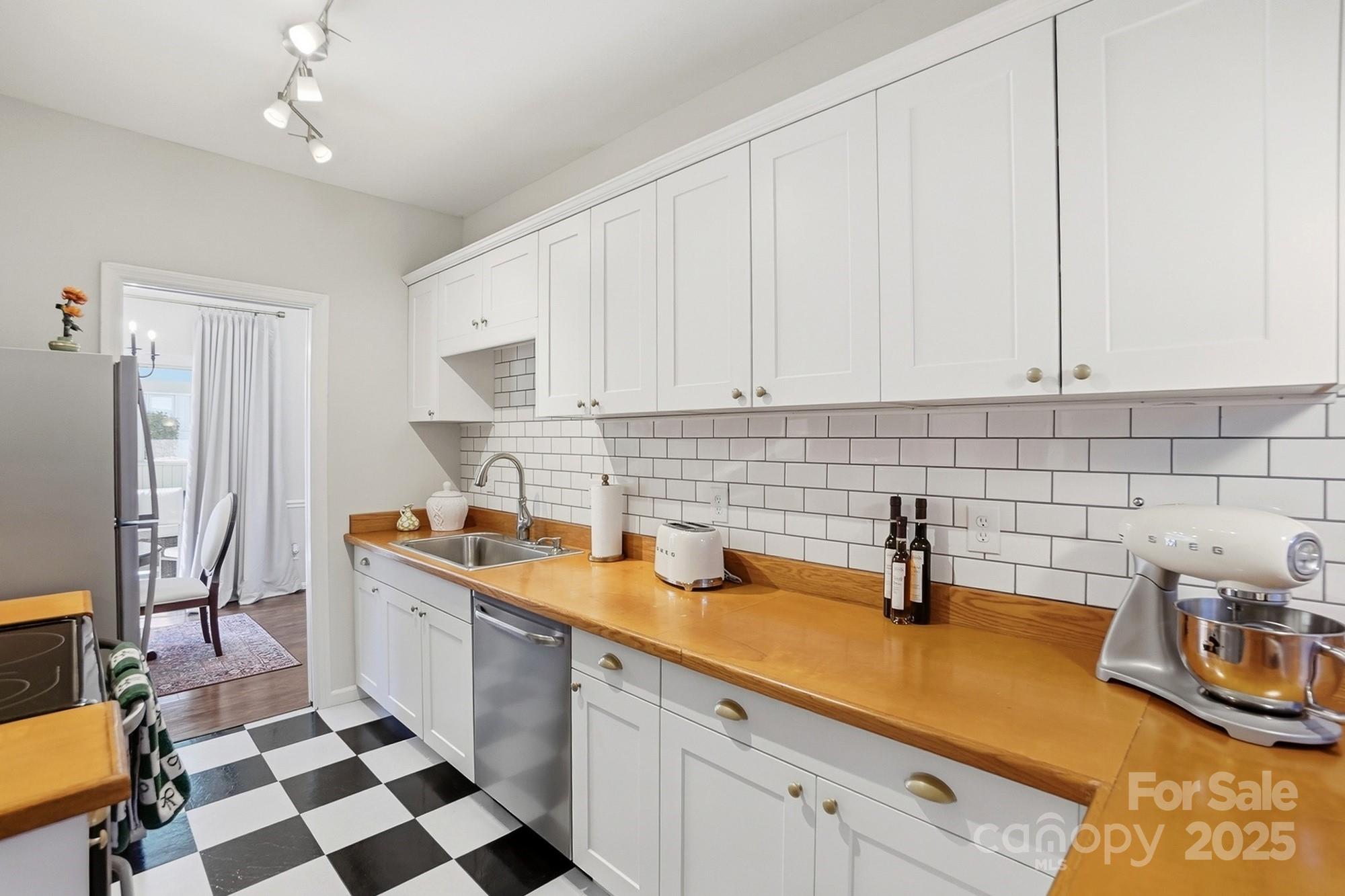 a kitchen with a sink a stove and cabinets