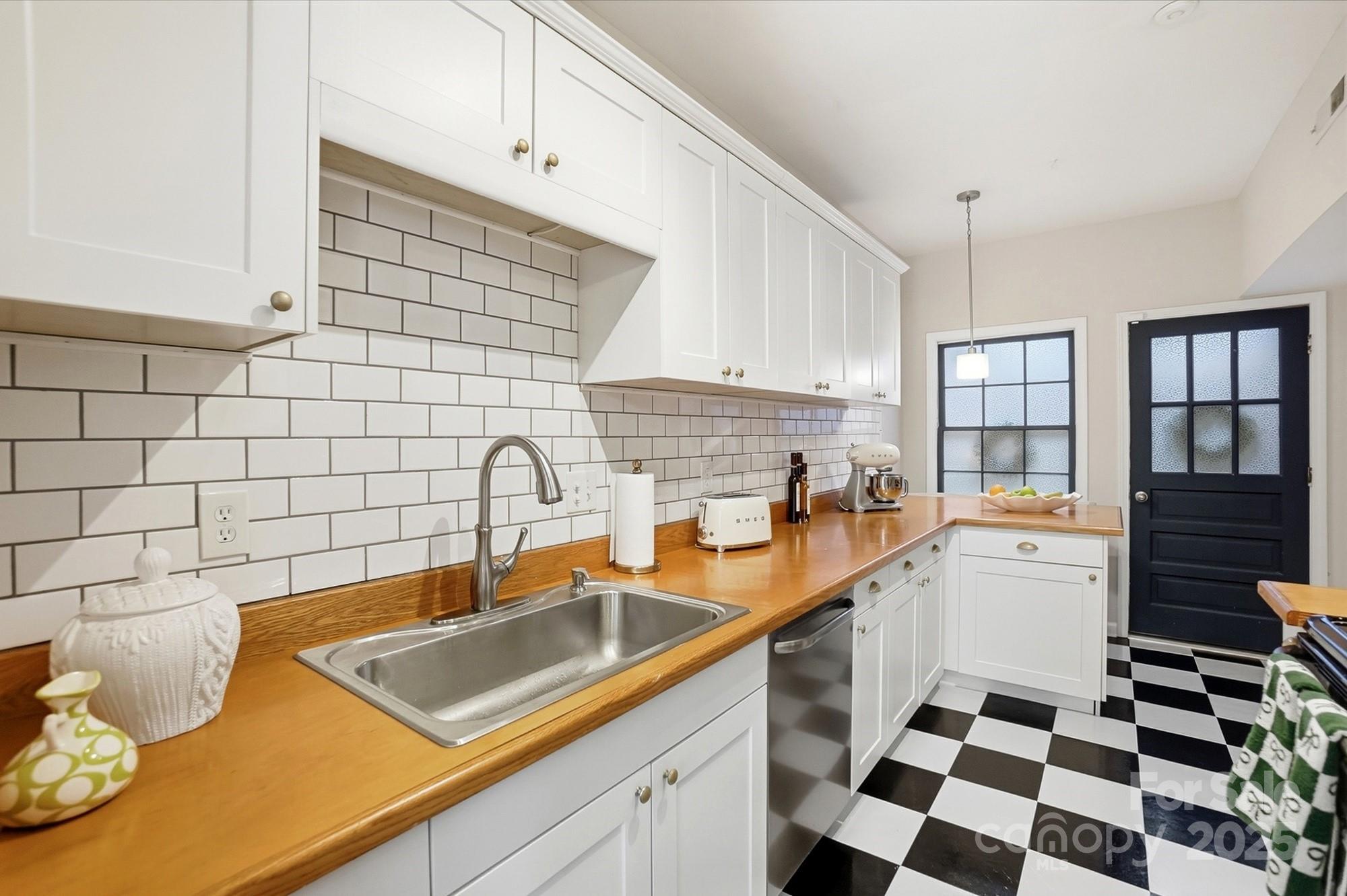 5913 Quail Hollow Road Charlotte, NC 28210 - Photo 17 of 47 a kitchen with a sink a stove and cabinets