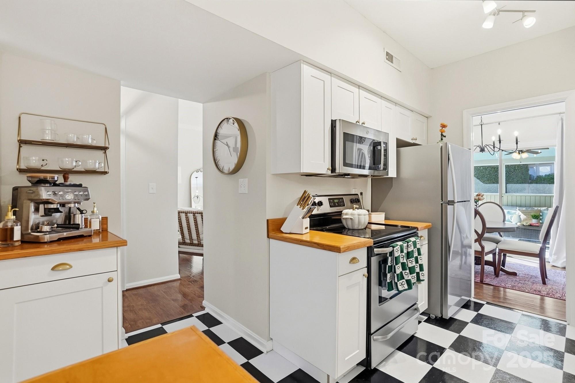 5913 Quail Hollow Road Charlotte, NC 28210 - Photo 21 of 47 a kitchen with stainless steel appliances a stove a sink and a refrigerator