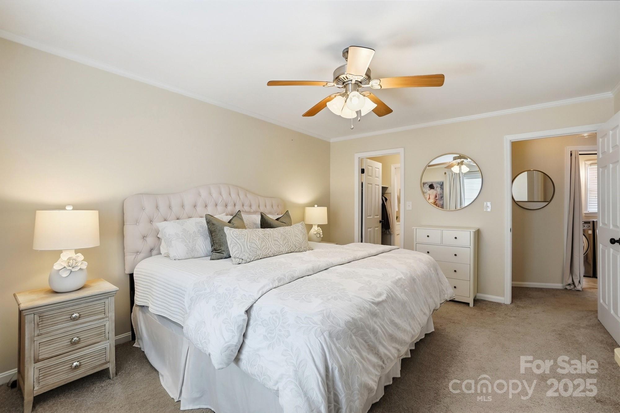 5913 Quail Hollow Road Charlotte, NC 28210 - Photo 31 of 47 a bedroom with a bed and a chandelier