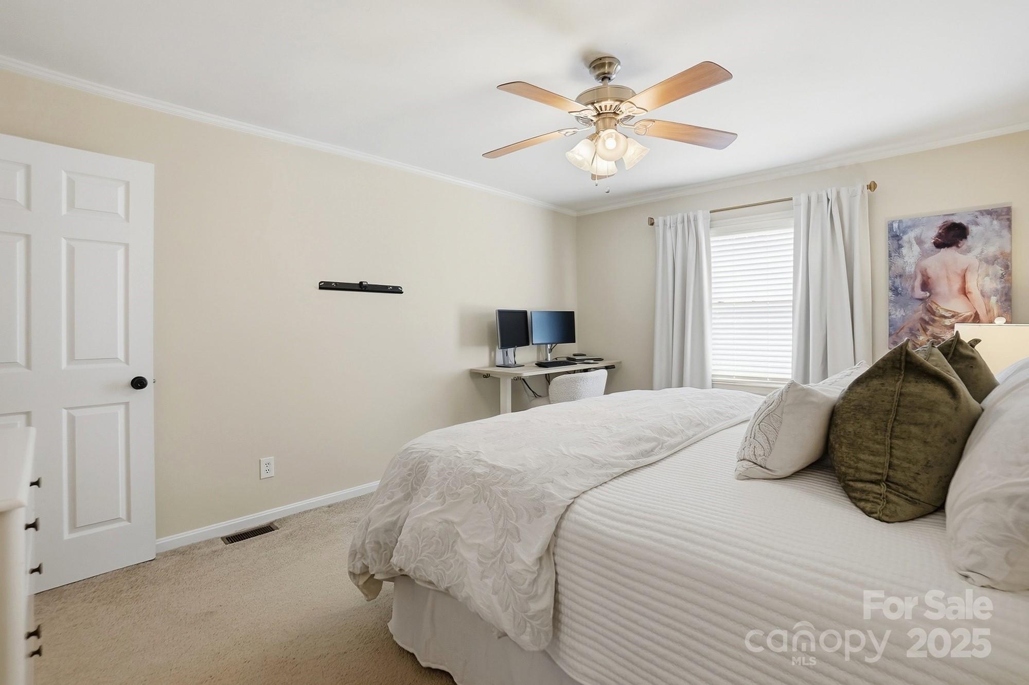 5913 Quail Hollow Road Charlotte, NC 28210 - Photo 32 of 47 a bedroom with a large bed and a chandelier