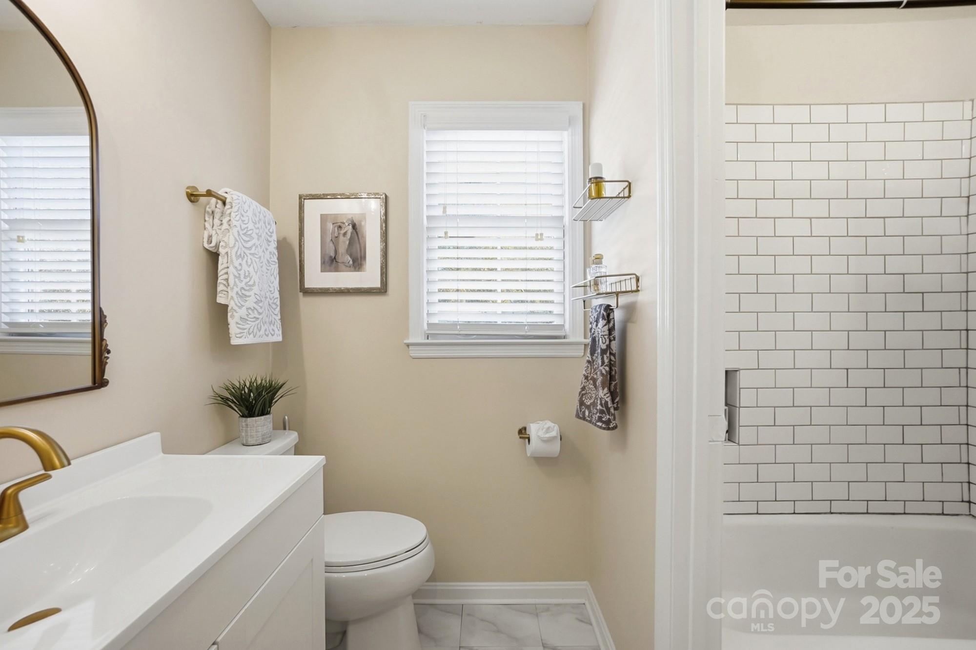 5913 Quail Hollow Road Charlotte, NC 28210 - Photo 36 of 47 a bathroom with a toilet a sink a shower and mirror