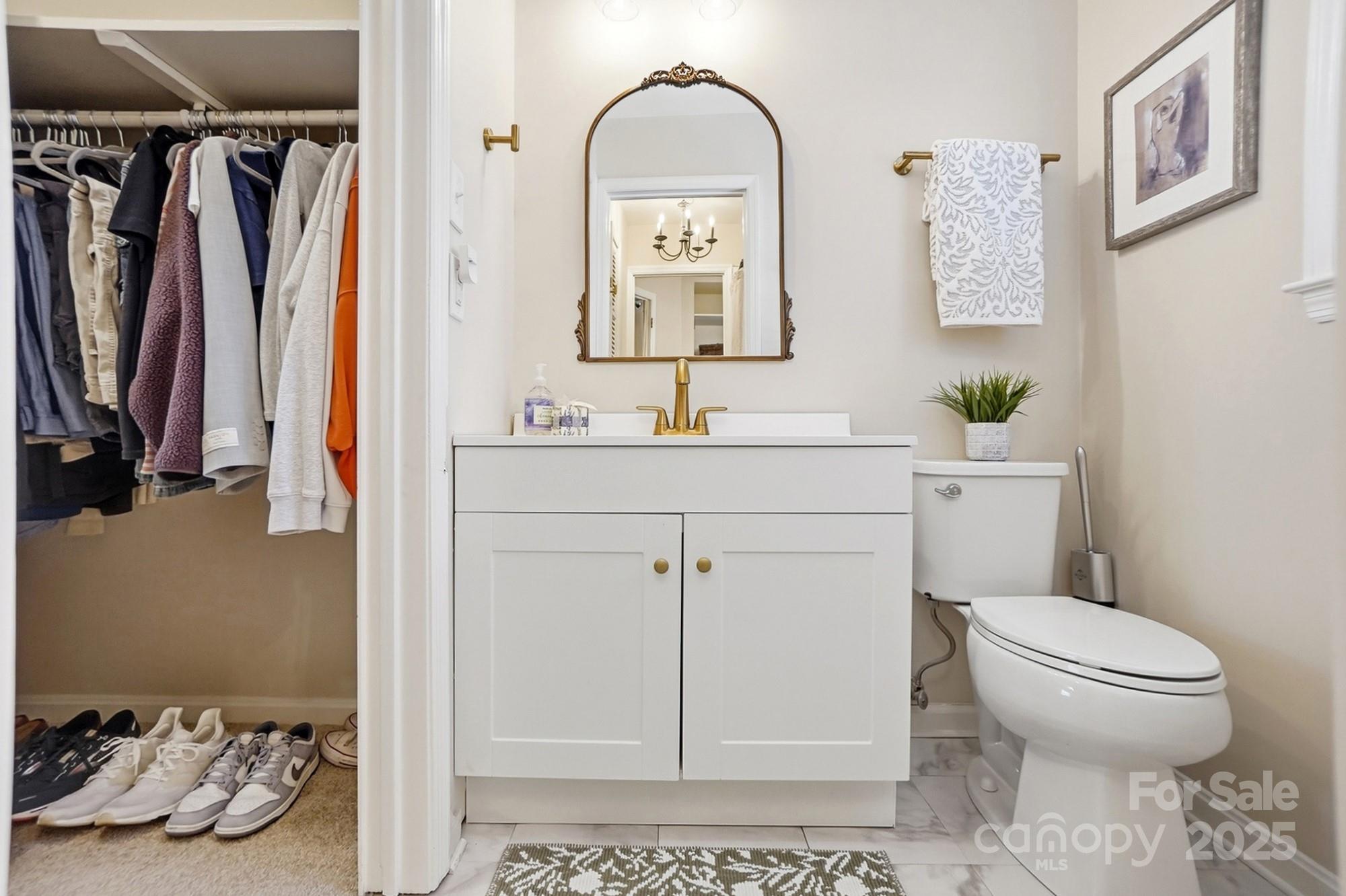 5913 Quail Hollow Road Charlotte, NC 28210 - Photo 38 of 47 a bathroom with a toilet sink and mirror