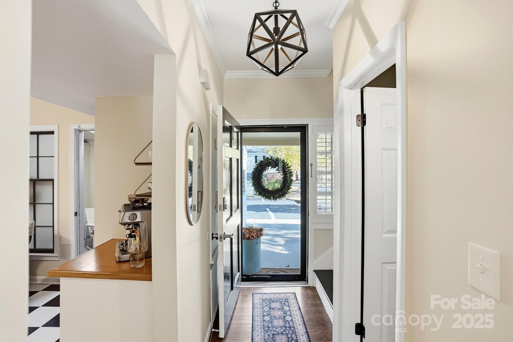 5913 Quail Hollow Road Charlotte, NC 28210 - Photo 5 of 47 a view of a hallway with wooden floor and a bathroom