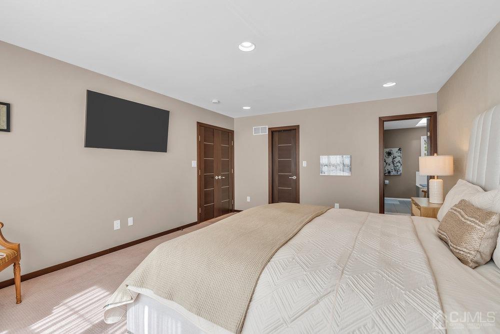 71 Stratton Road Old Bridge, NJ 07747 - Photo 44 of 77 a spacious bedroom with a bed and a flat screen tv