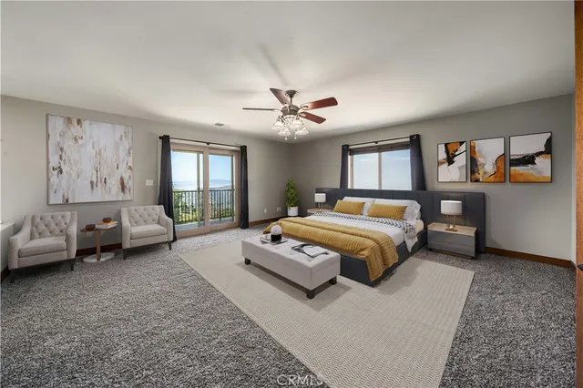 a bedroom with a large bed couch and a window