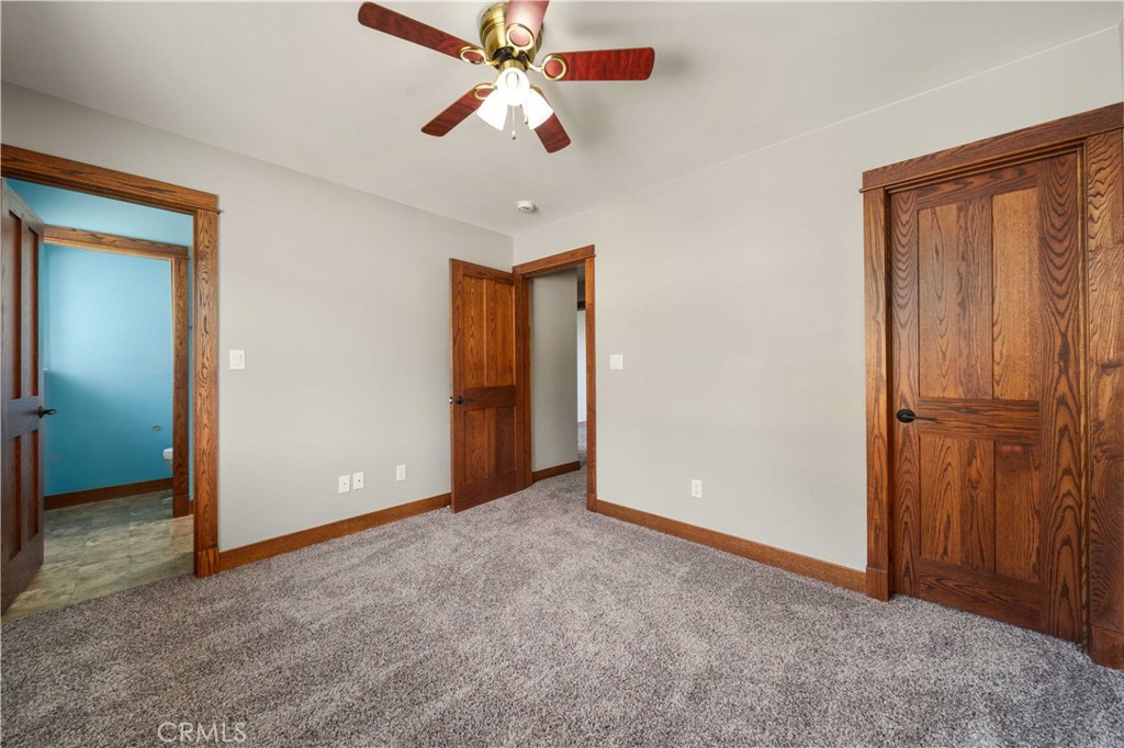 29600 Goldspike Road Tehachapi, CA 93561 - Photo 15 of 48 an empty room with closet and a chandelier fan