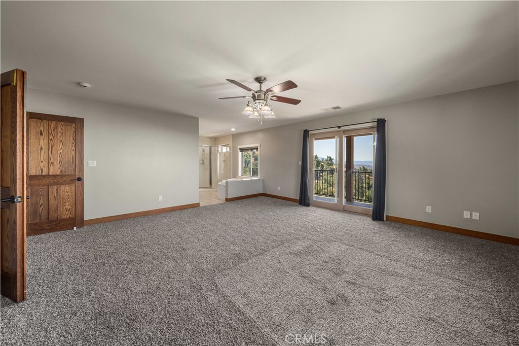 29600 Goldspike Road Tehachapi, CA 93561 - Photo 17 of 48 an empty room with chandelier fan and windows