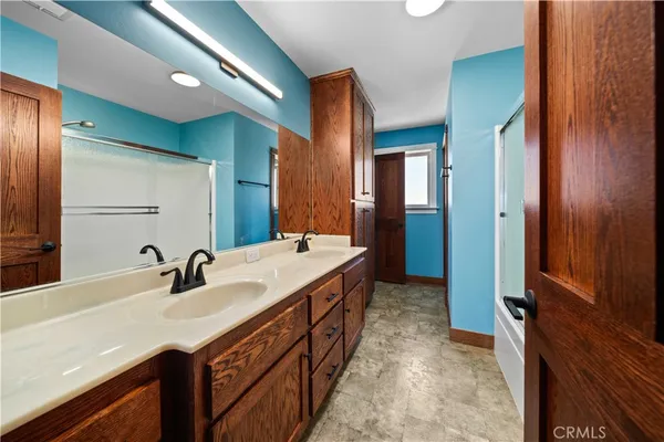 a bathroom with a double vanity sink and a mirror