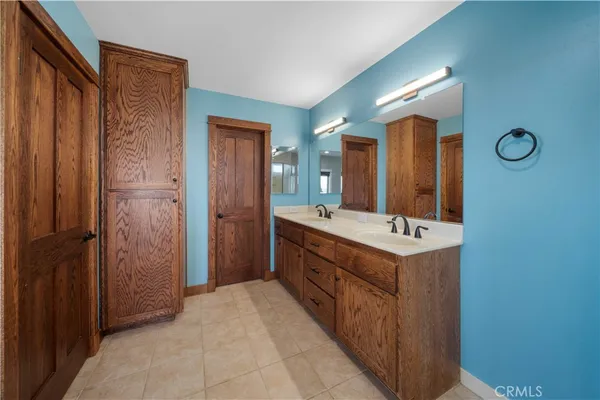 a bathroom with a double vanity sink mirror and shower