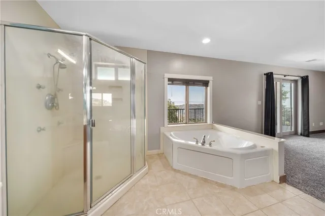 a spacious bathroom with a tub shower and sink