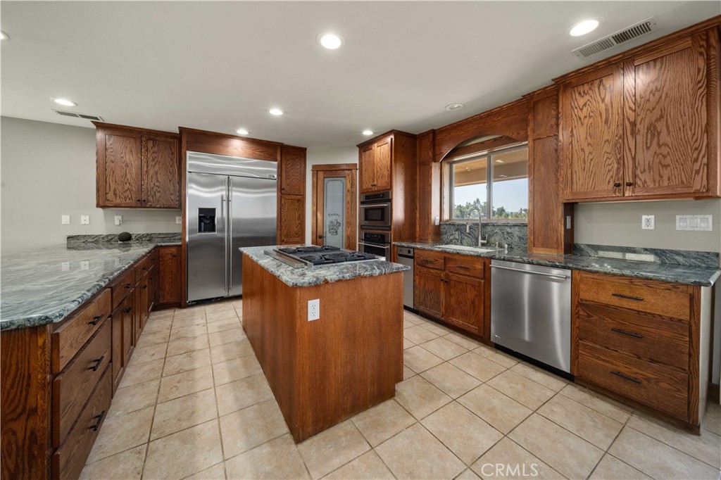 29600 Goldspike Road Tehachapi, CA 93561 - Photo 6 of 48 a large kitchen with stainless steel appliances granite countertop a stove a sink and a refrigerator