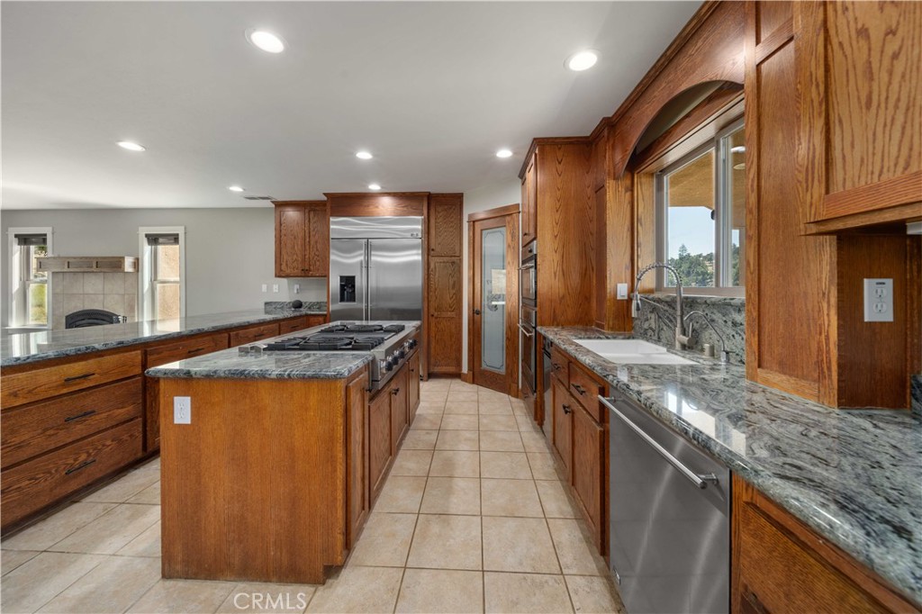 29600 Goldspike Road Tehachapi, CA 93561 - Photo 7 of 48 a large kitchen with stainless steel appliances granite countertop a large stove a sink and a refrigerator