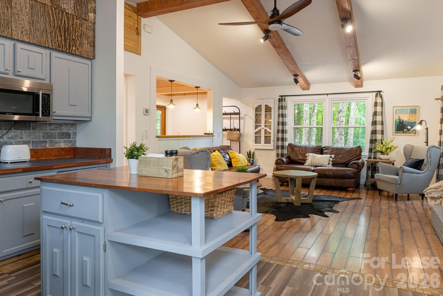 260 Allison Hill Road Brevard, NC 28712 - Photo 26 of 41 a living room with furniture a large window and stainless steel appliances