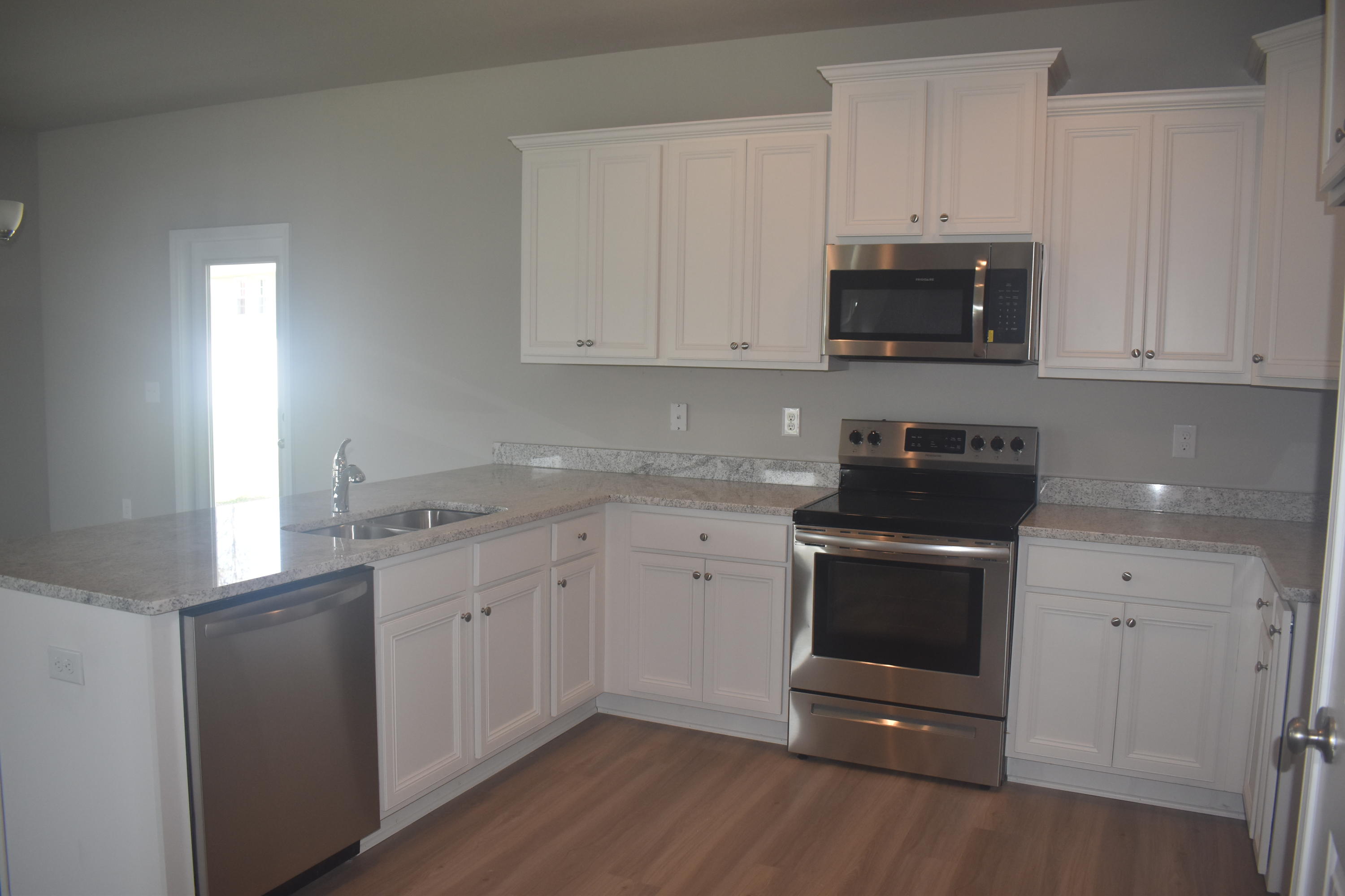 204 Southern Pnes Road Santa Rosa Beach, FL 32459 - Photo 3 of 47 a kitchen with granite countertop white cabinets and stainless steel appliances