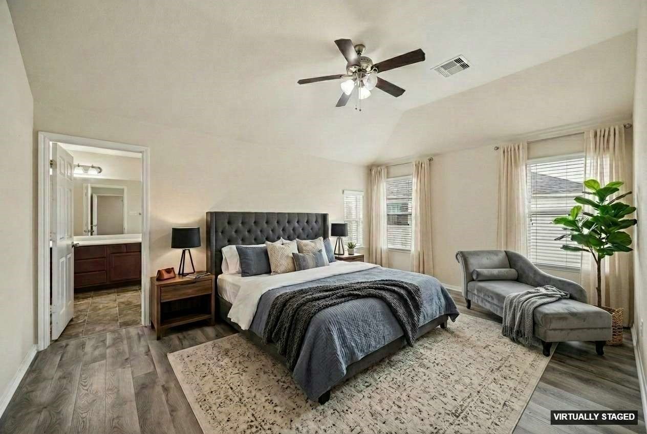 15642 South Fall Fern Circle Houston, TX 77044 - Photo 18 of 32 a bedroom with a bed a couch and potted plant with the dresser