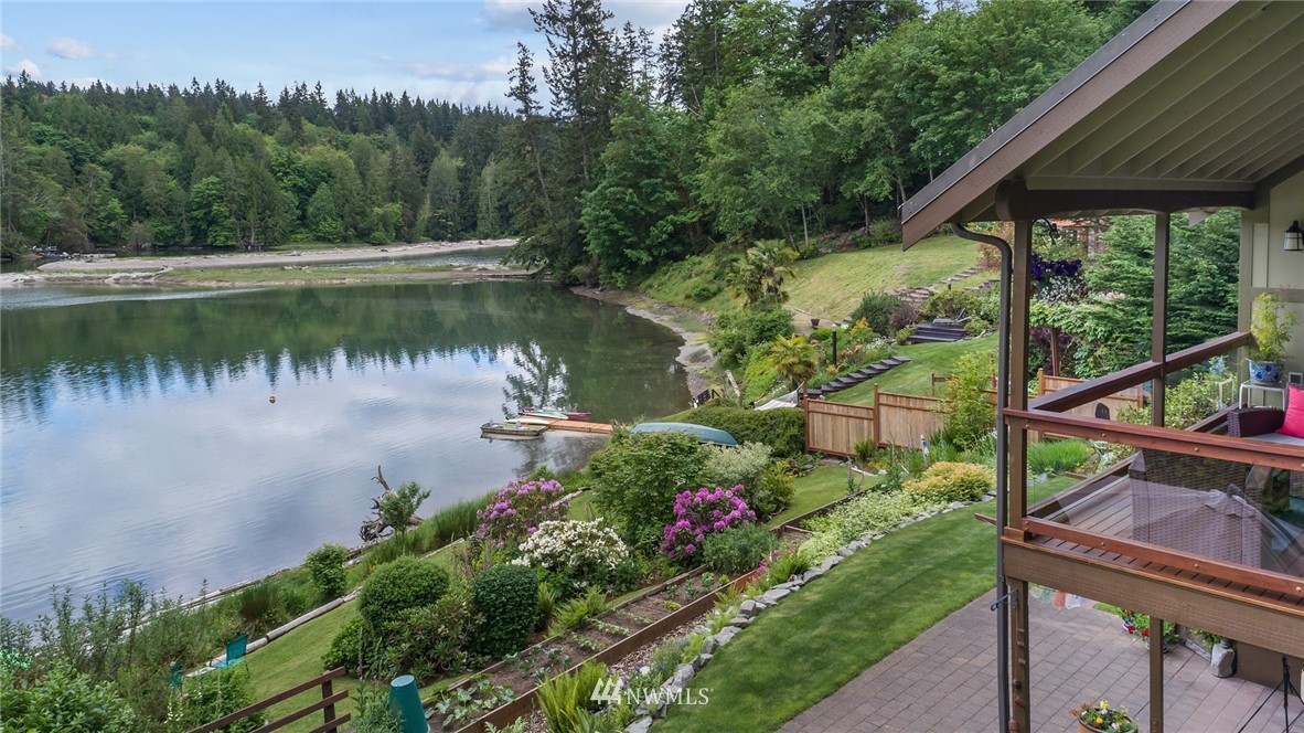 5909 Crescent Beach Road Northwest Vaughn, WA 98394 - Photo 2 of 35 a view of a garden with a lake
