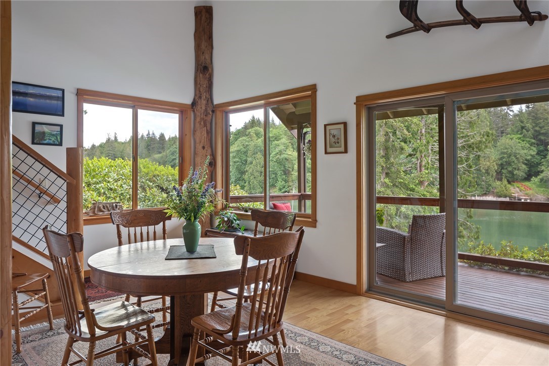 5909 Crescent Beach Road Northwest Vaughn, WA 98394 - Photo 14 of 35 a view of a dining room with furniture window and wooden floor